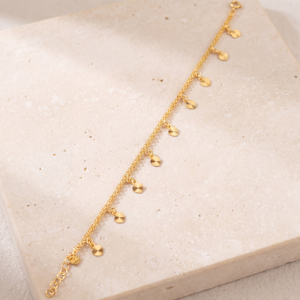 Charm Bracelet (D36) on travertine