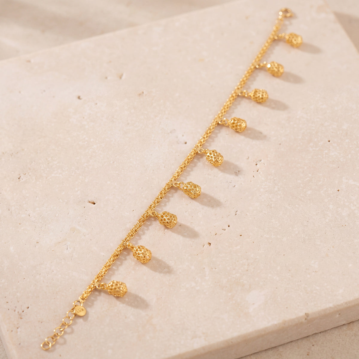 Charm Bracelet (D55) on travertine