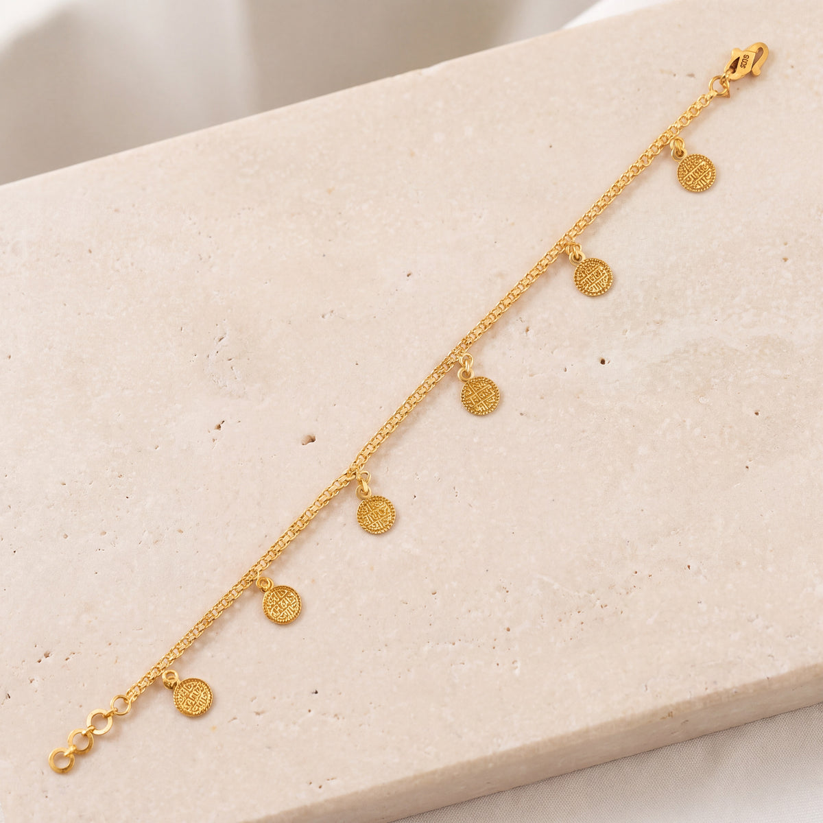 Coin Bracelet (D6) on travertine