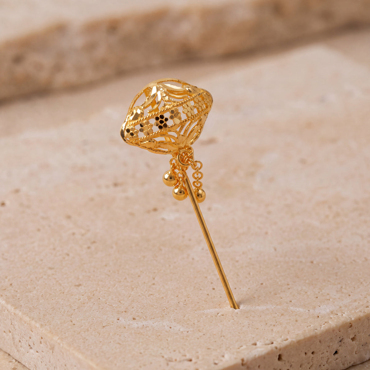 Daboos (D15) scarf pin on travertine stone