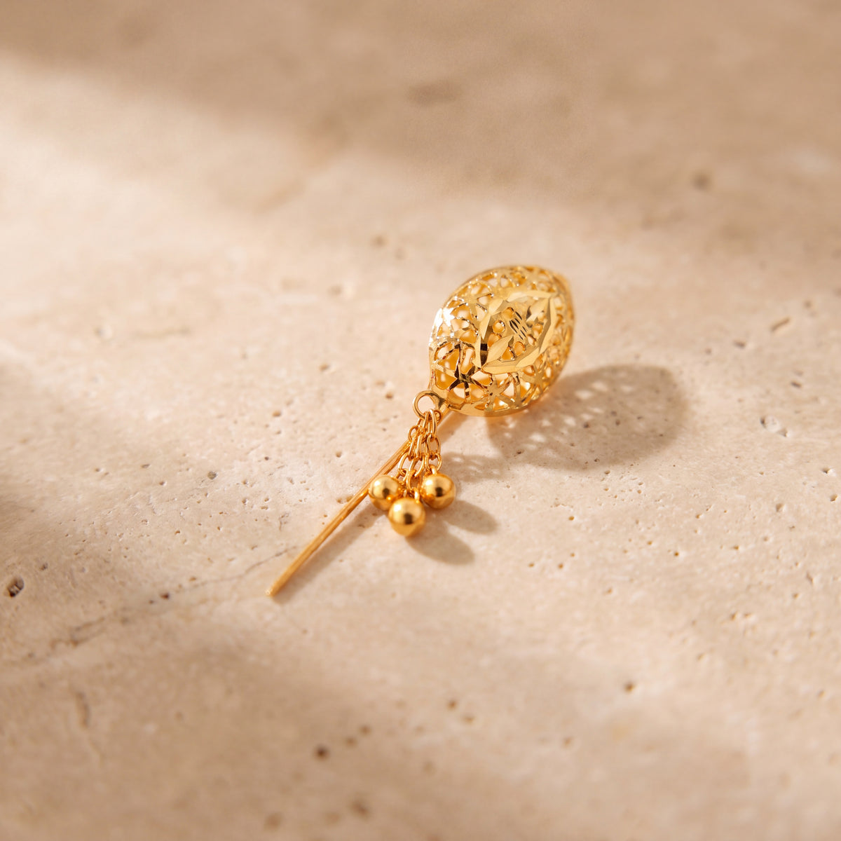Daboos (D41) scarf pin on travertine stone