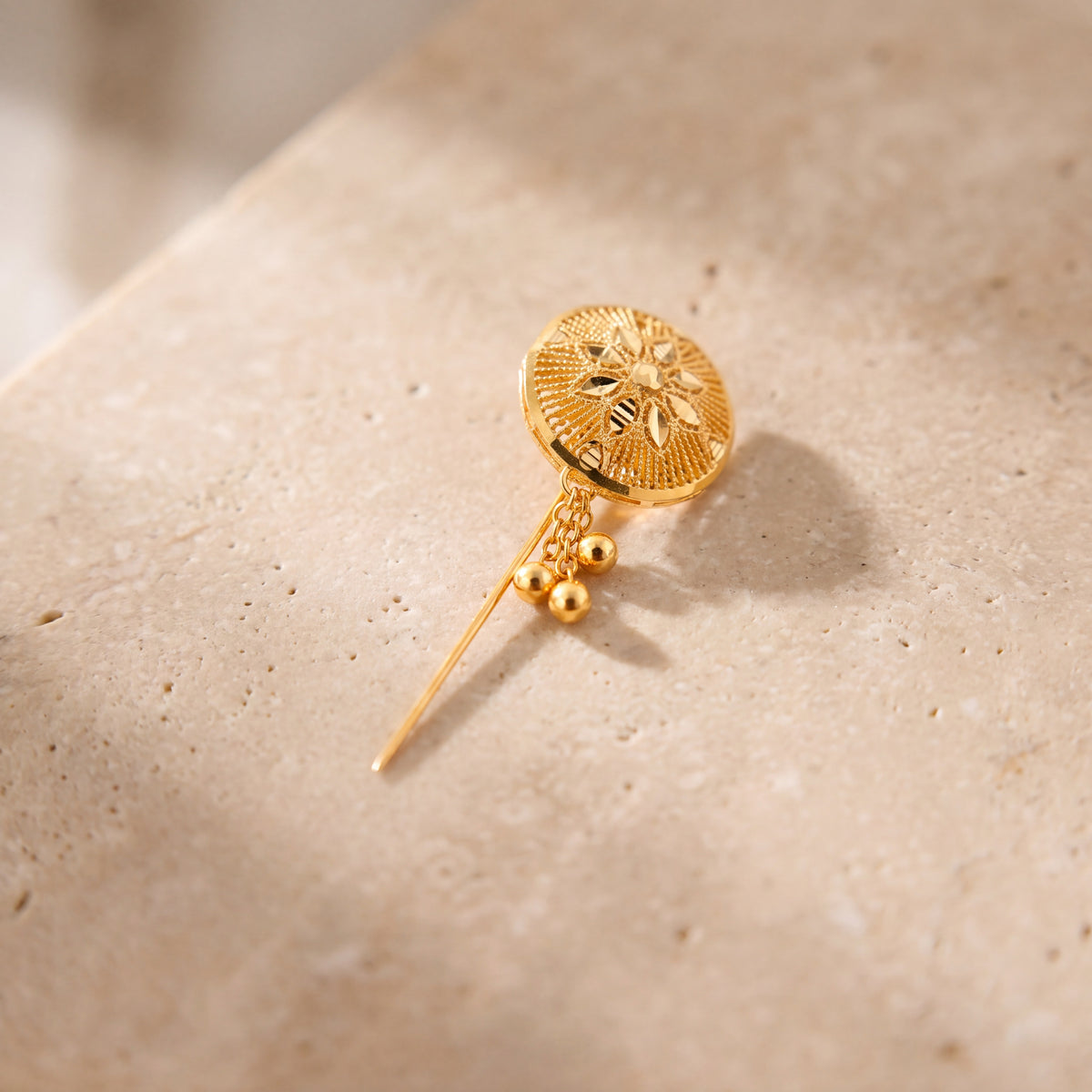 Daboos (D45) scarf pin on travertine stone