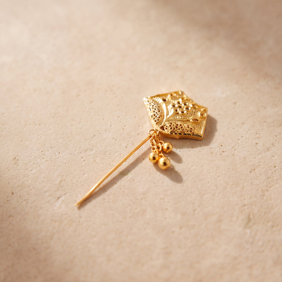 Daboos (D47) scarf pin on travertine stone