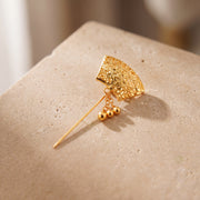 Daboos (D48) scarf pin on travertine stone