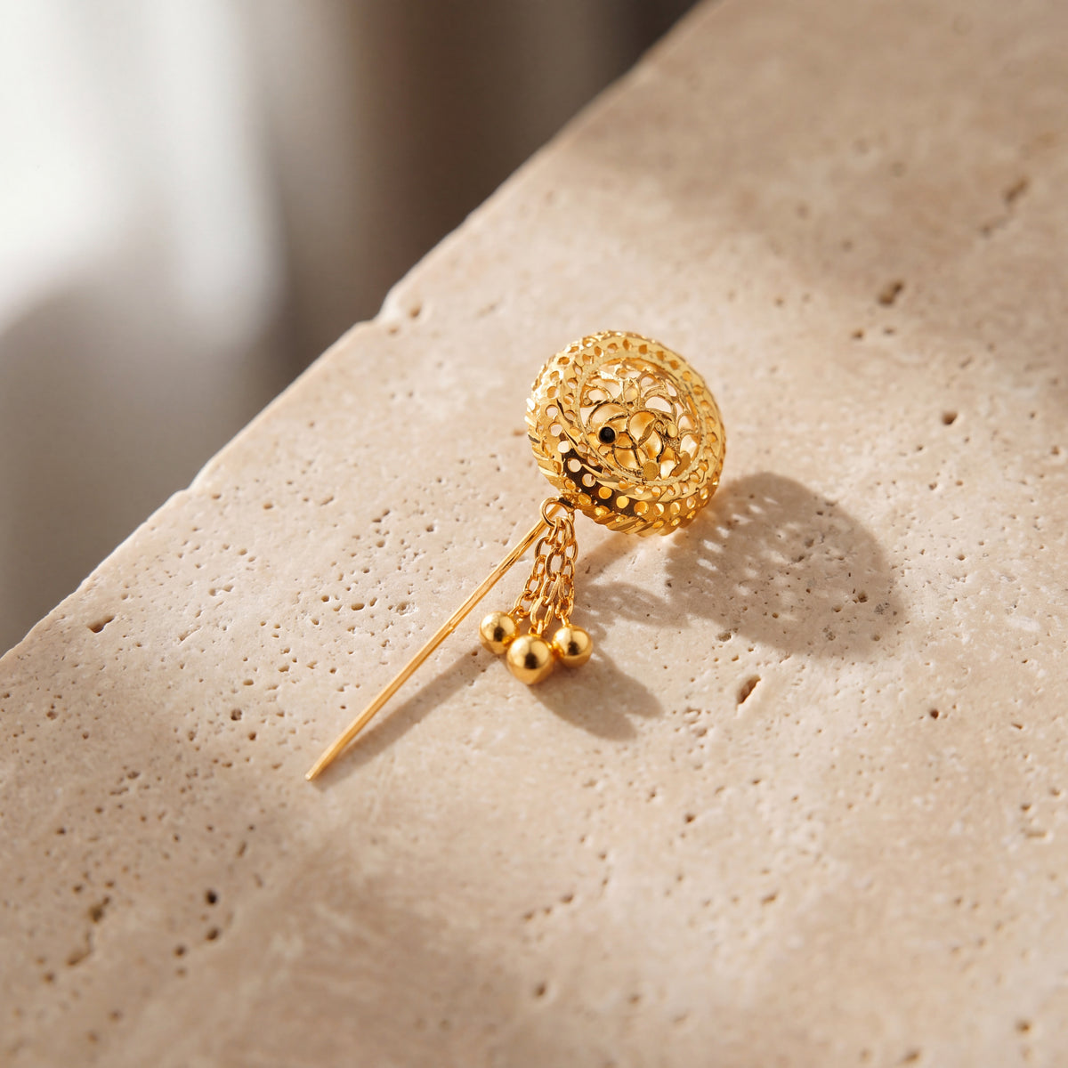 Daboos (D50) scarf pin on travertine stone