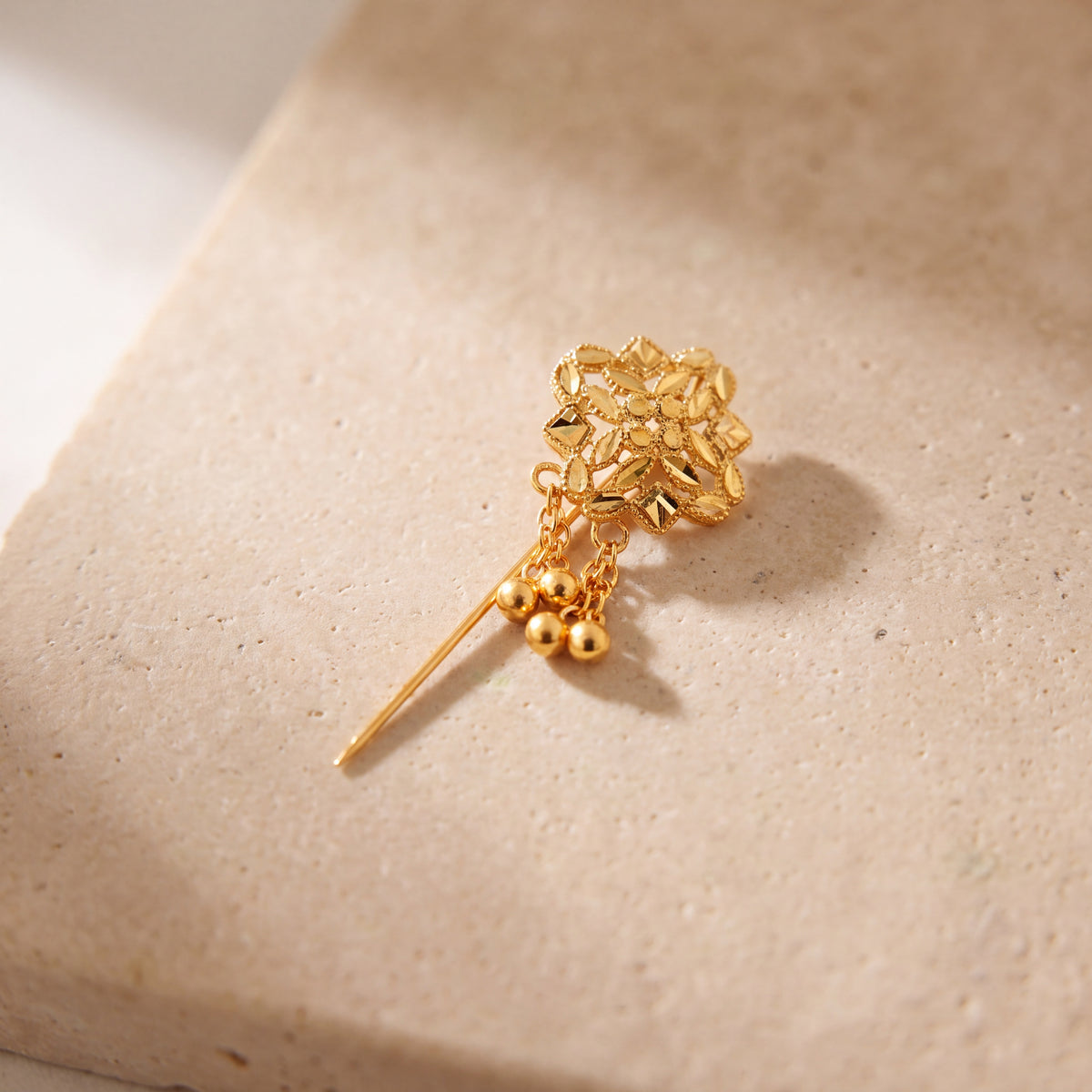 Daboos (D51) scarf pin on travertine stone