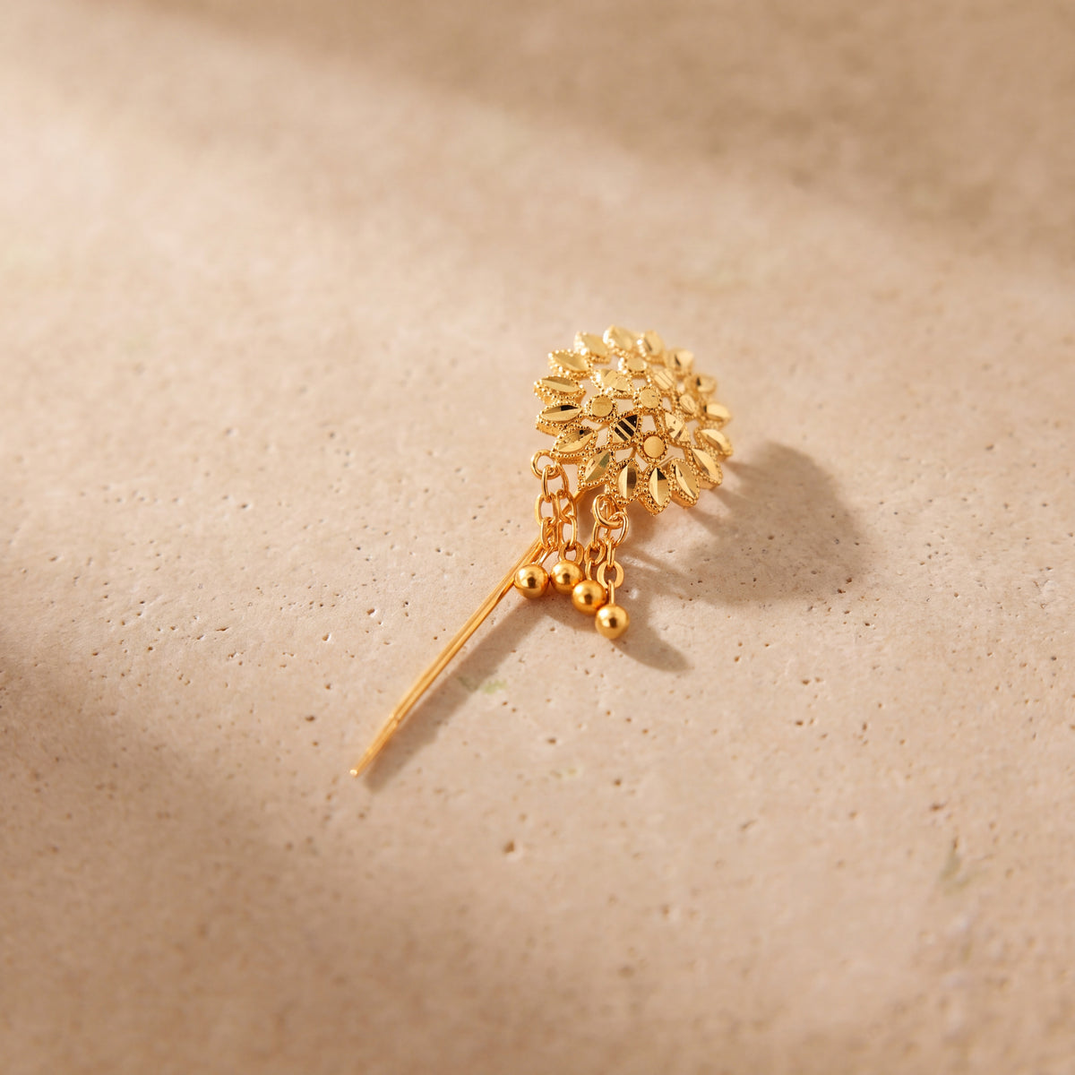 Daboos (D55) scarf pin on travertine stone