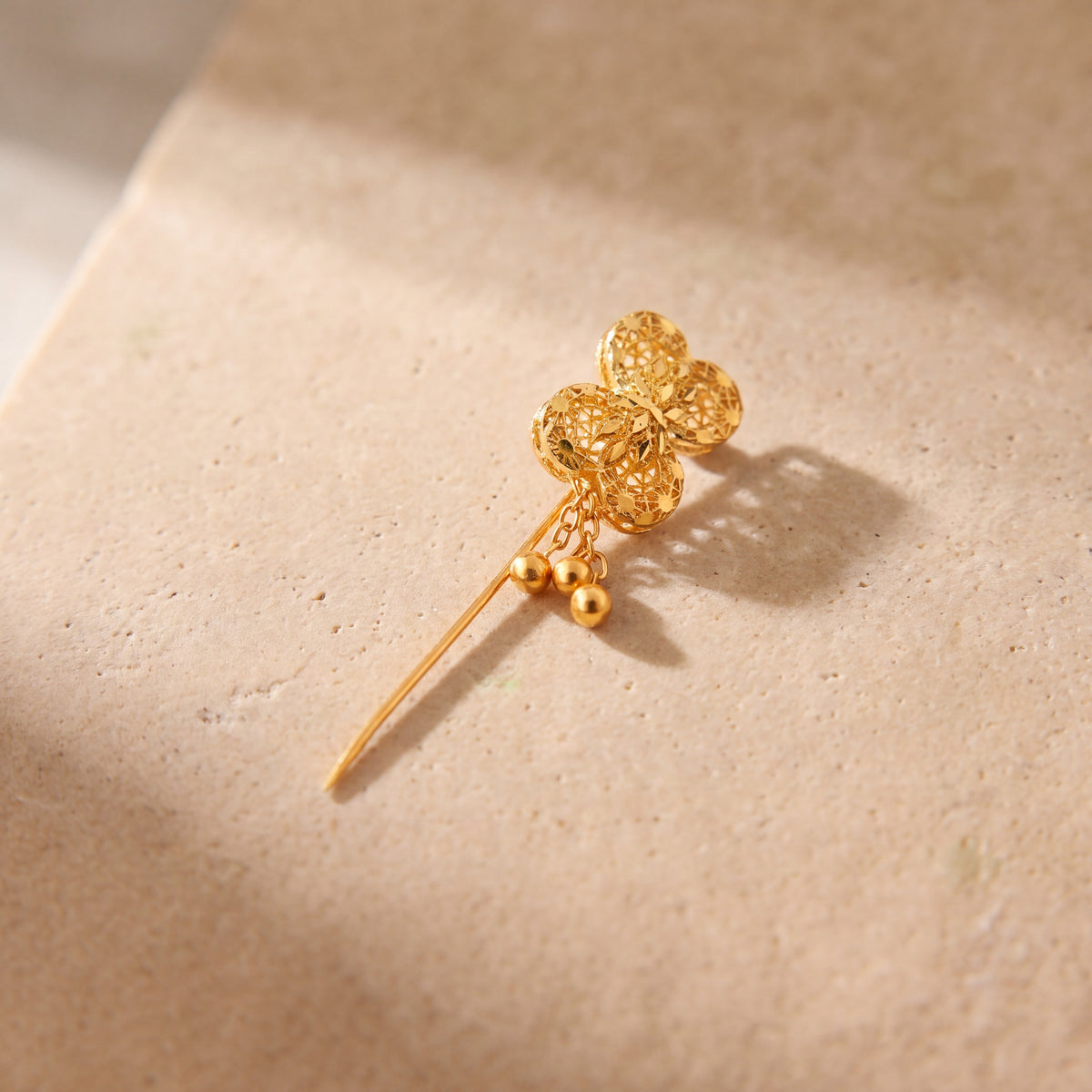 Daboos (D56) scarf pin on travertine stone
