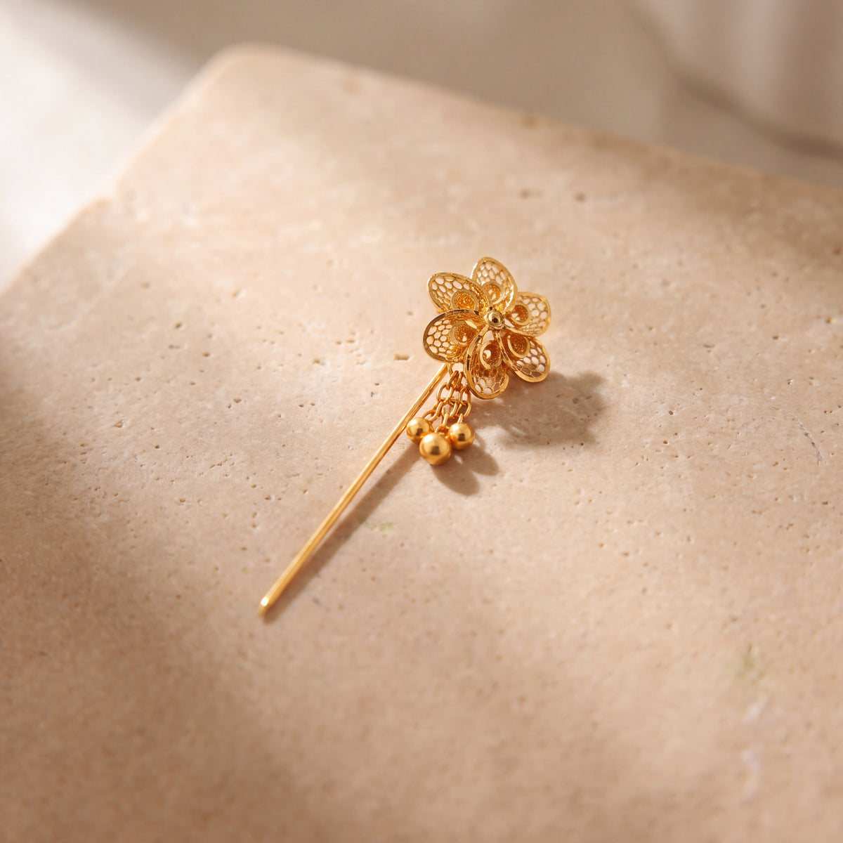 Daboos (D57) scarf pin on travertine stone
