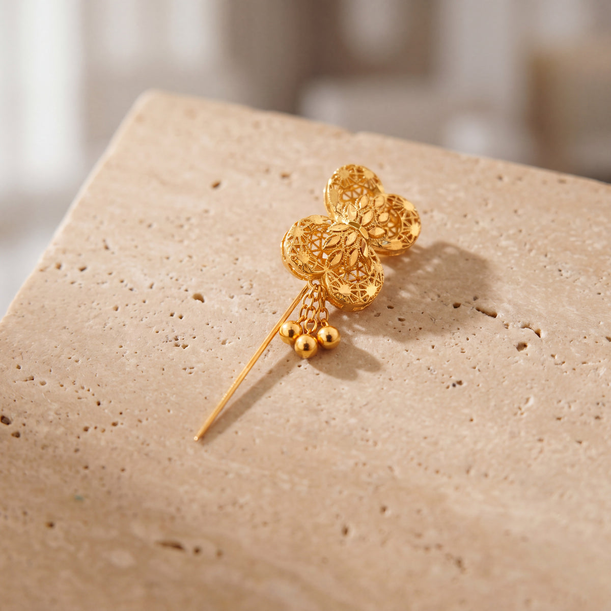 Daboos (D58) scarf pin on travertine stone