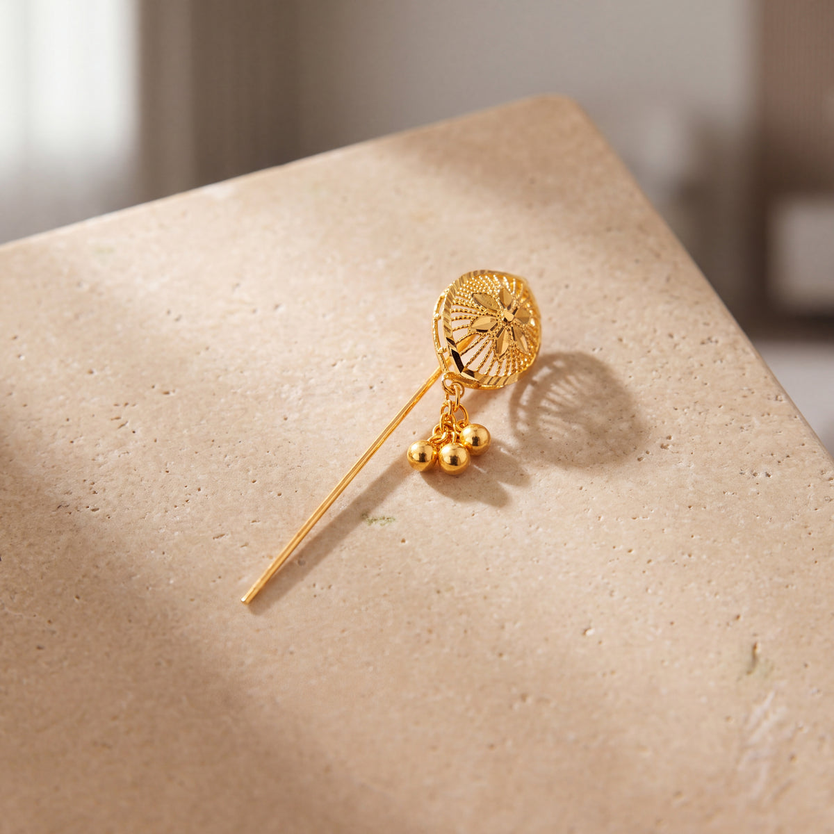 Daboos (D60) scarf pin on travertine stone