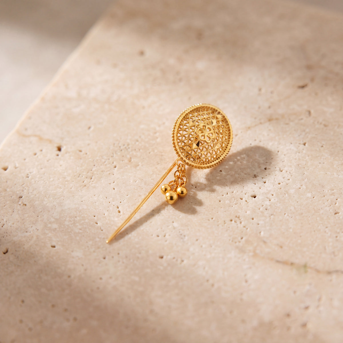 Daboos (D62) scarf pin on travertine stone