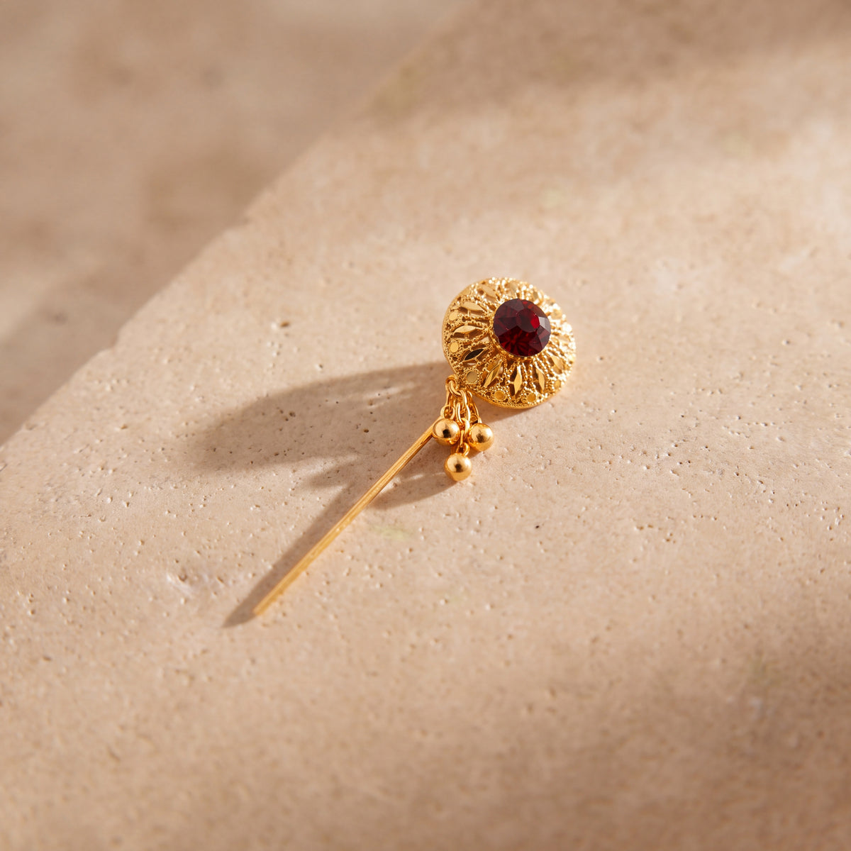 Daboos (D63) scarf pin on travertine stone