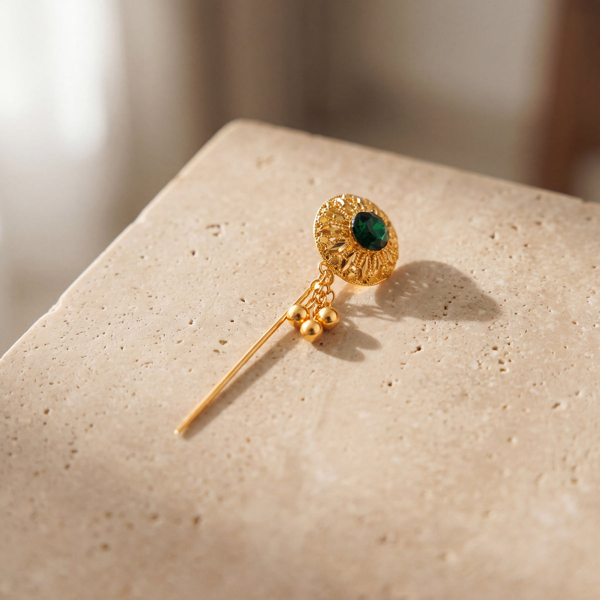 Daboos (D64) scarf pin on travertine stone