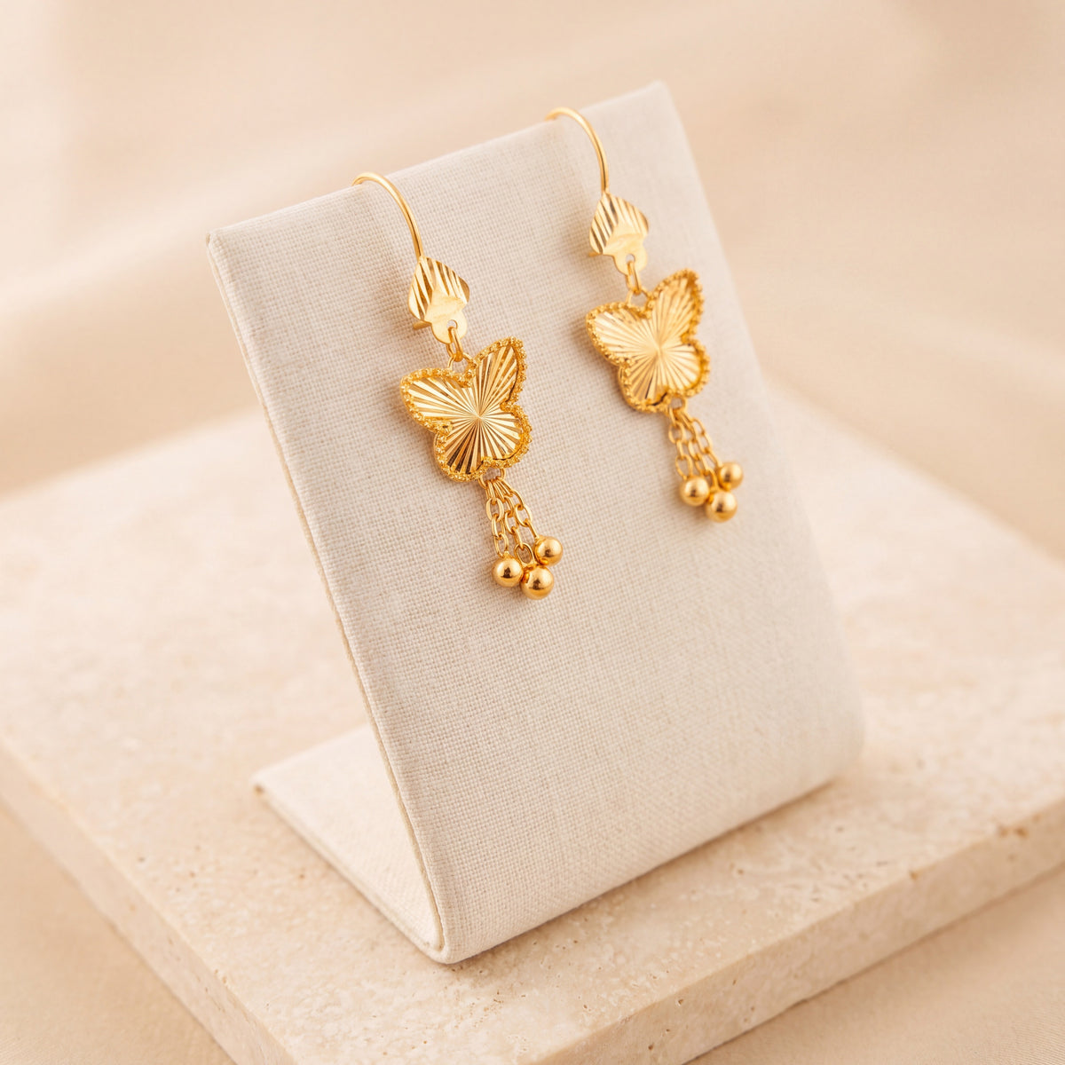 Butterfly Earrings 3 – Butterfly with dangles, on travertine