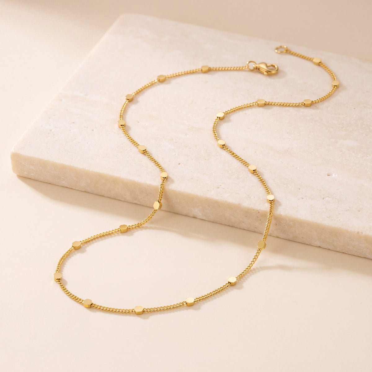 Fancy Chain 1 laid flat on travertine