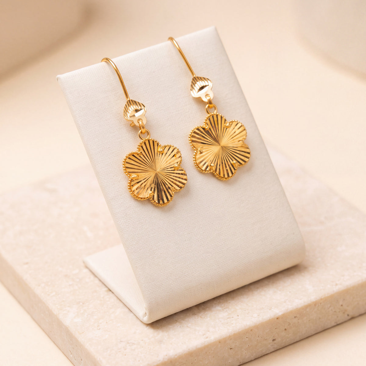 Flower Earrings V1 – Gold flower earrings, on travertine