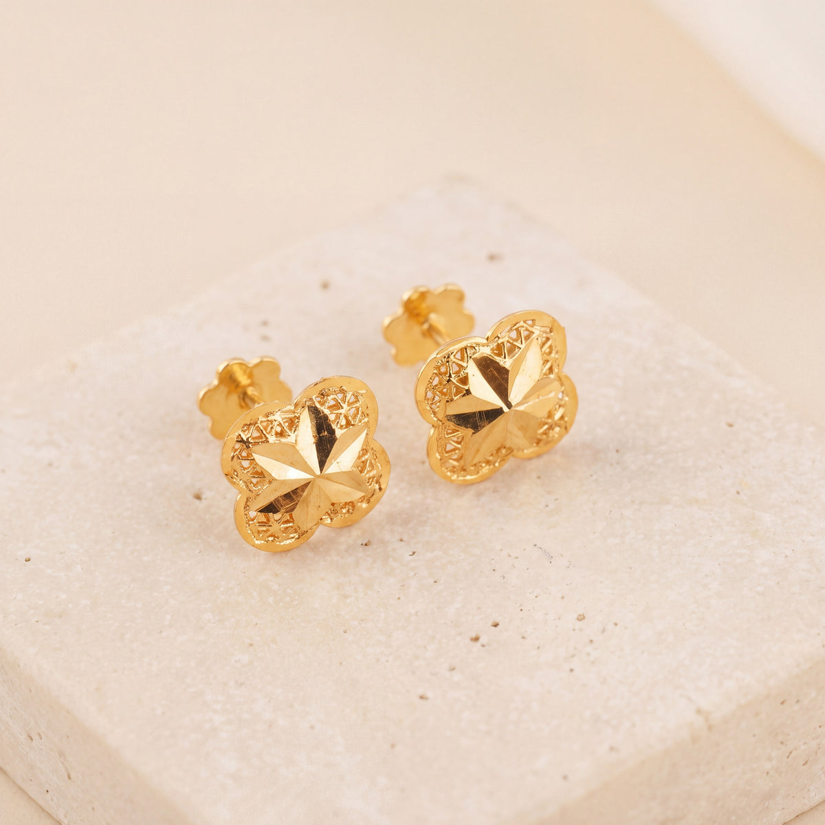 Four Petal Stud Earrings 1 on travertine