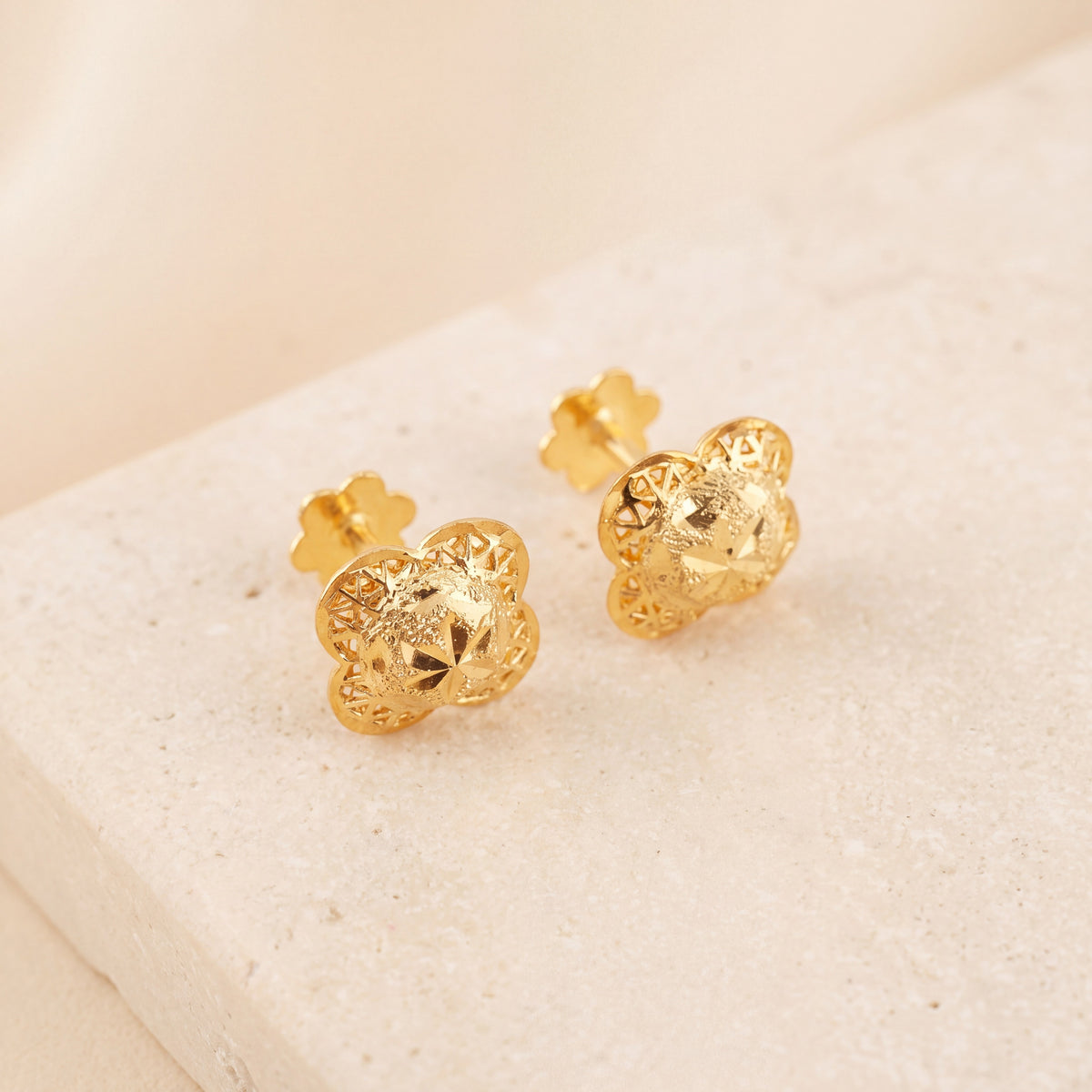 Four Petal Stud Earrings 2 on travertine
