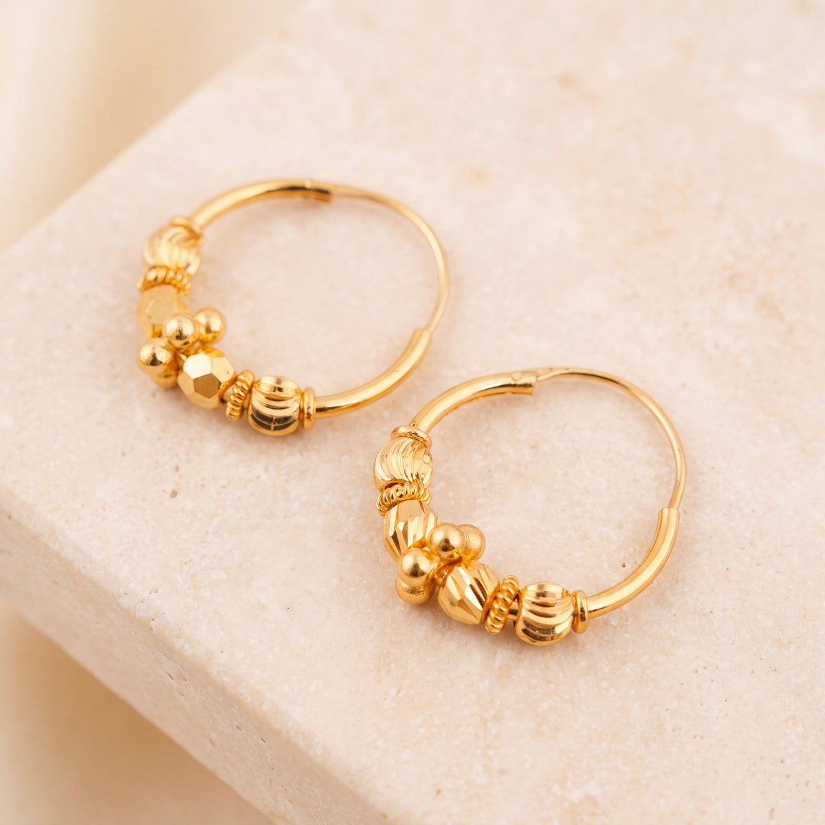 Hoop Earrings D31- (V1) on travertine