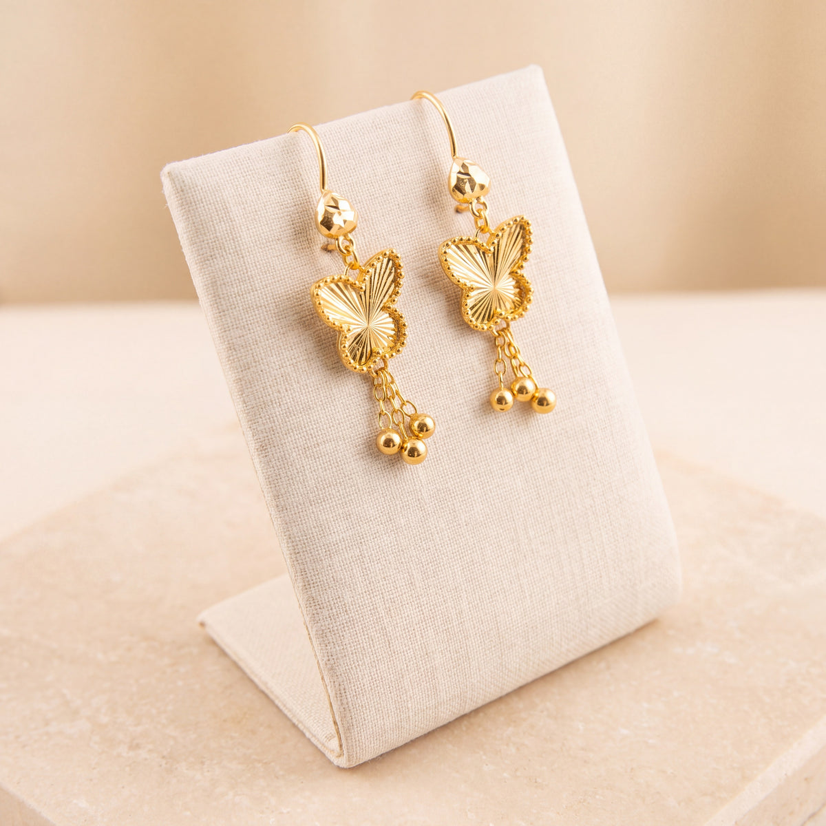 Kids Butterfly Earrings 4 on travertine