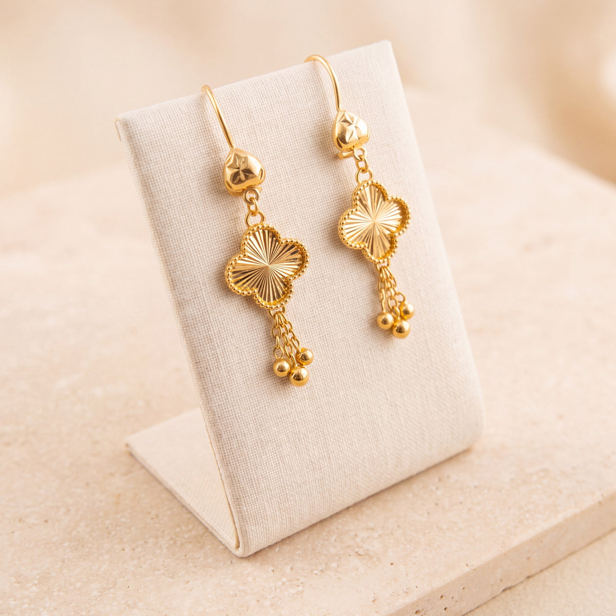 Kids Four-Leaf Clover Earrings 2 on travertine