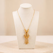 Kids RP Mala Necklace 2 – Gold necklace with round beads, on travertine