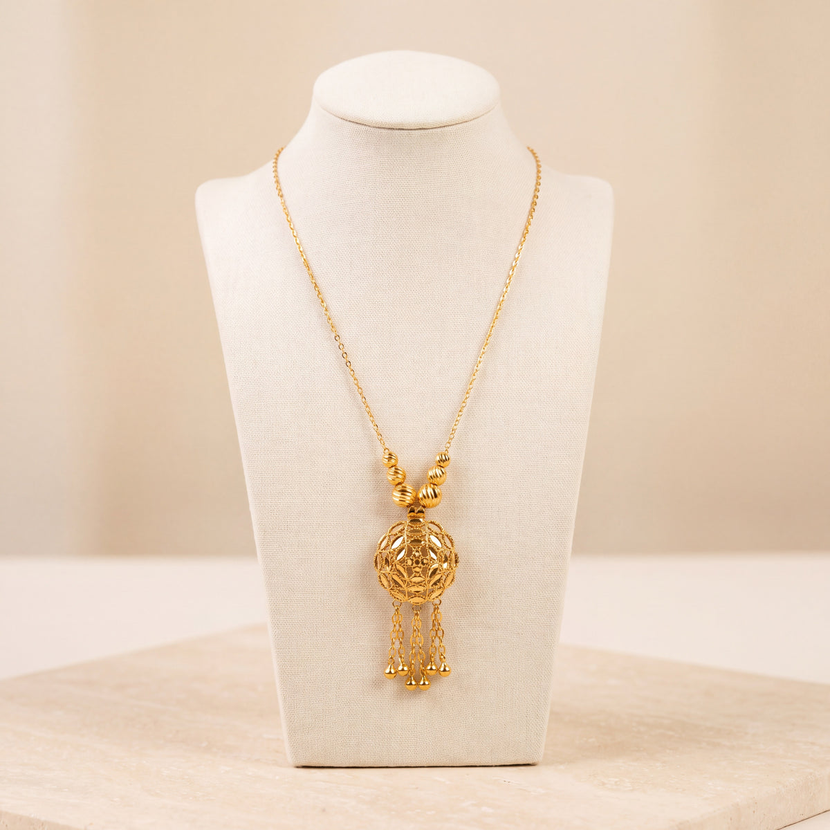 Kids RP Mala Necklace 2 – Gold necklace with round beads, on travertine