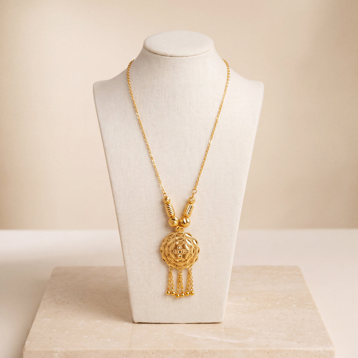 Kids RP Mala Necklace 2 – Gold necklace with cylindrical beads, on travertine