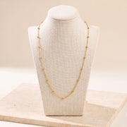 Link with Ball Chain 1 on travertine