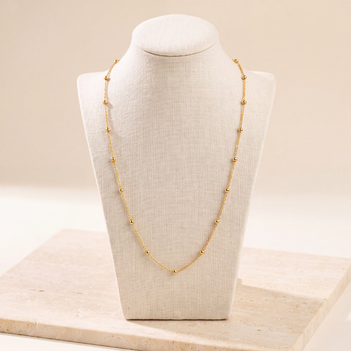 Link with Ball Chain 1 on travertine