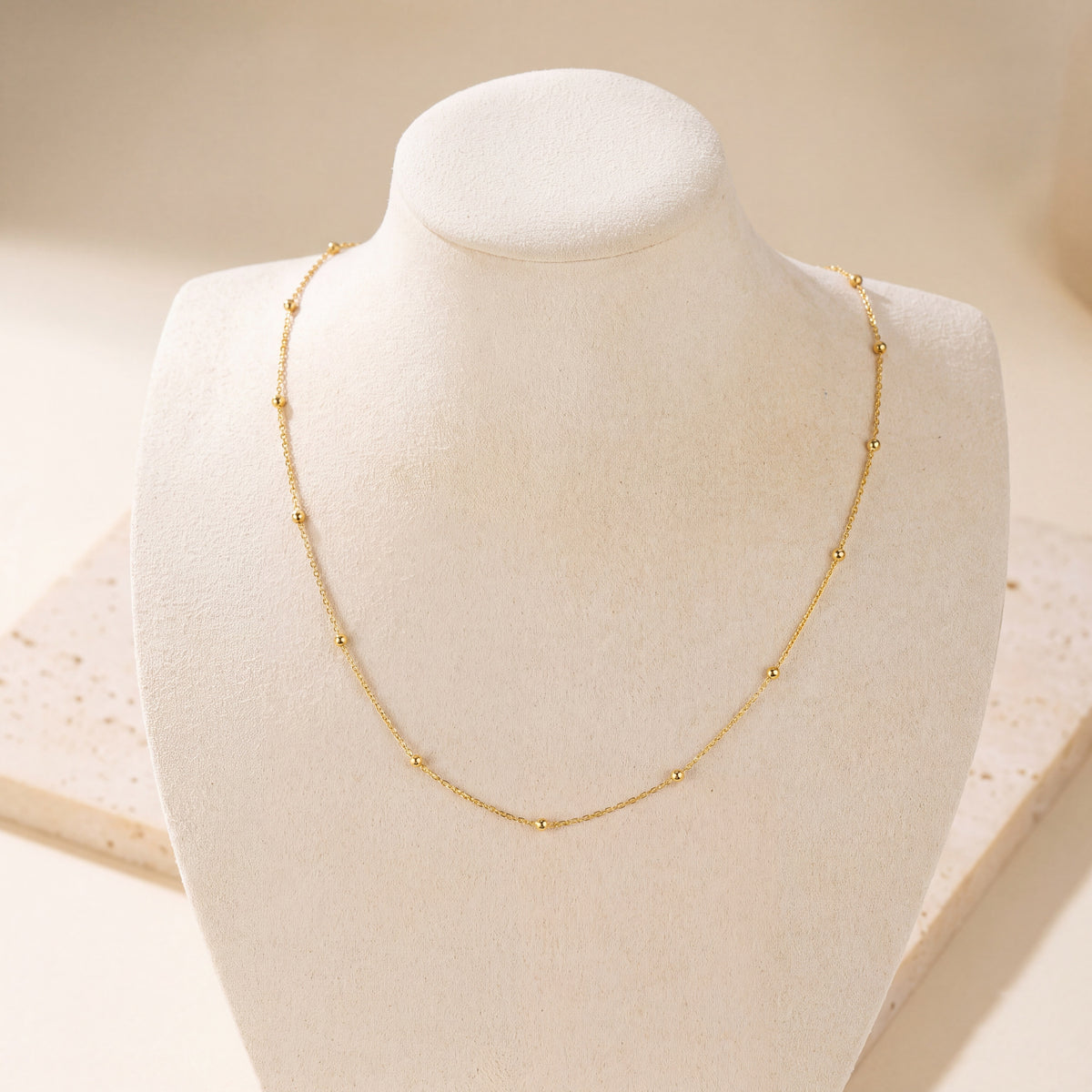 Link with Ball Chain 3 on travertine