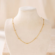 Link with Ball Chain 5 on travertine