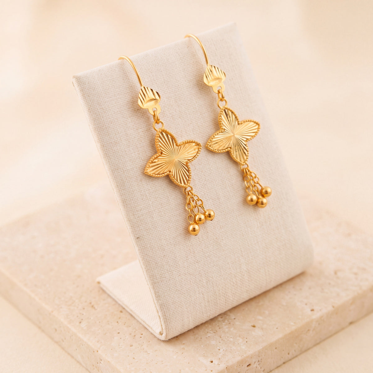 Petal Flower Earrings 3 – Gold clover with dangles, on travertine