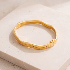 Gold Plated Cuff Bracelet (D1) on travertine