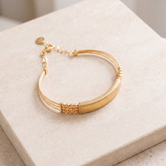 Gold Plated Cuff Bracelet (D10) on travertine