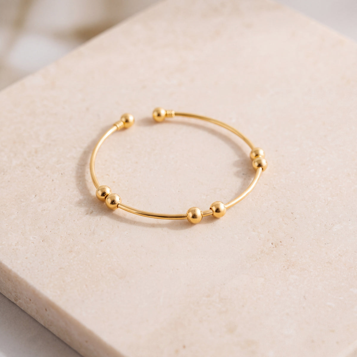 Gold Plated Cuff Bracelet (D2) on travertine