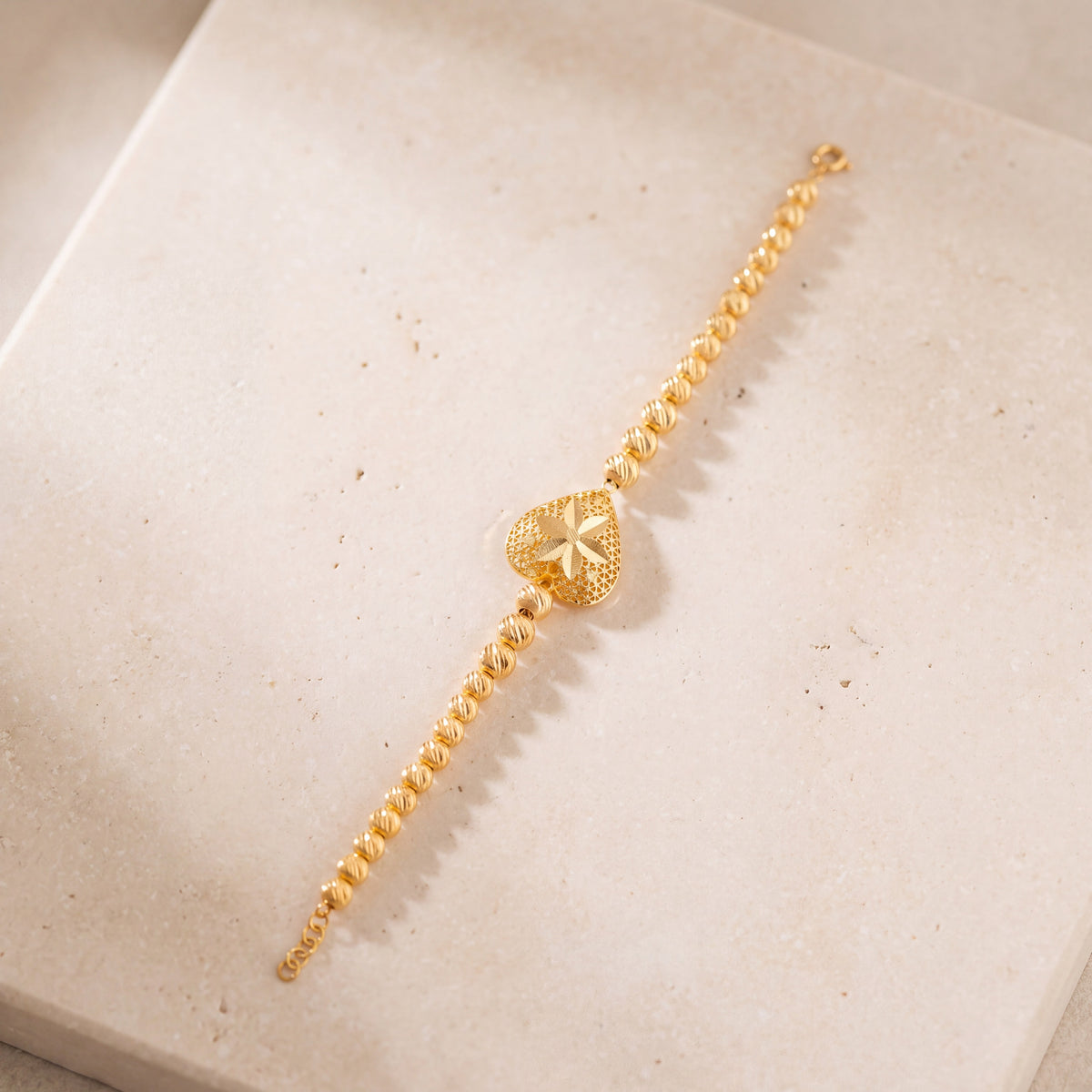Heart Bracelet with Beads (D1) on travertine