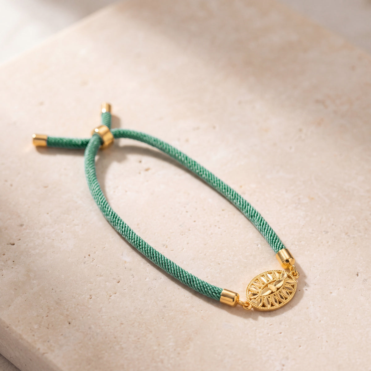 Oval Leaf Thread Bracelet on travertine