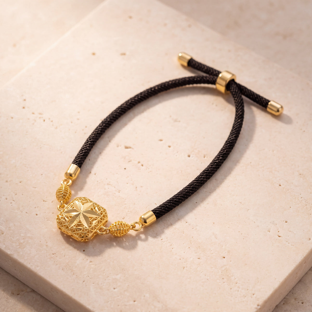 Quatrefoil Star Thread Bracelet on travertine