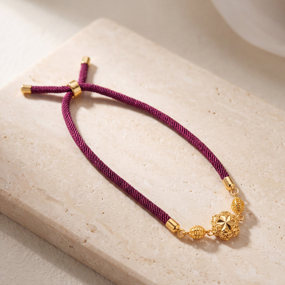 Quatrefoil Thread Bracelet on travertine
