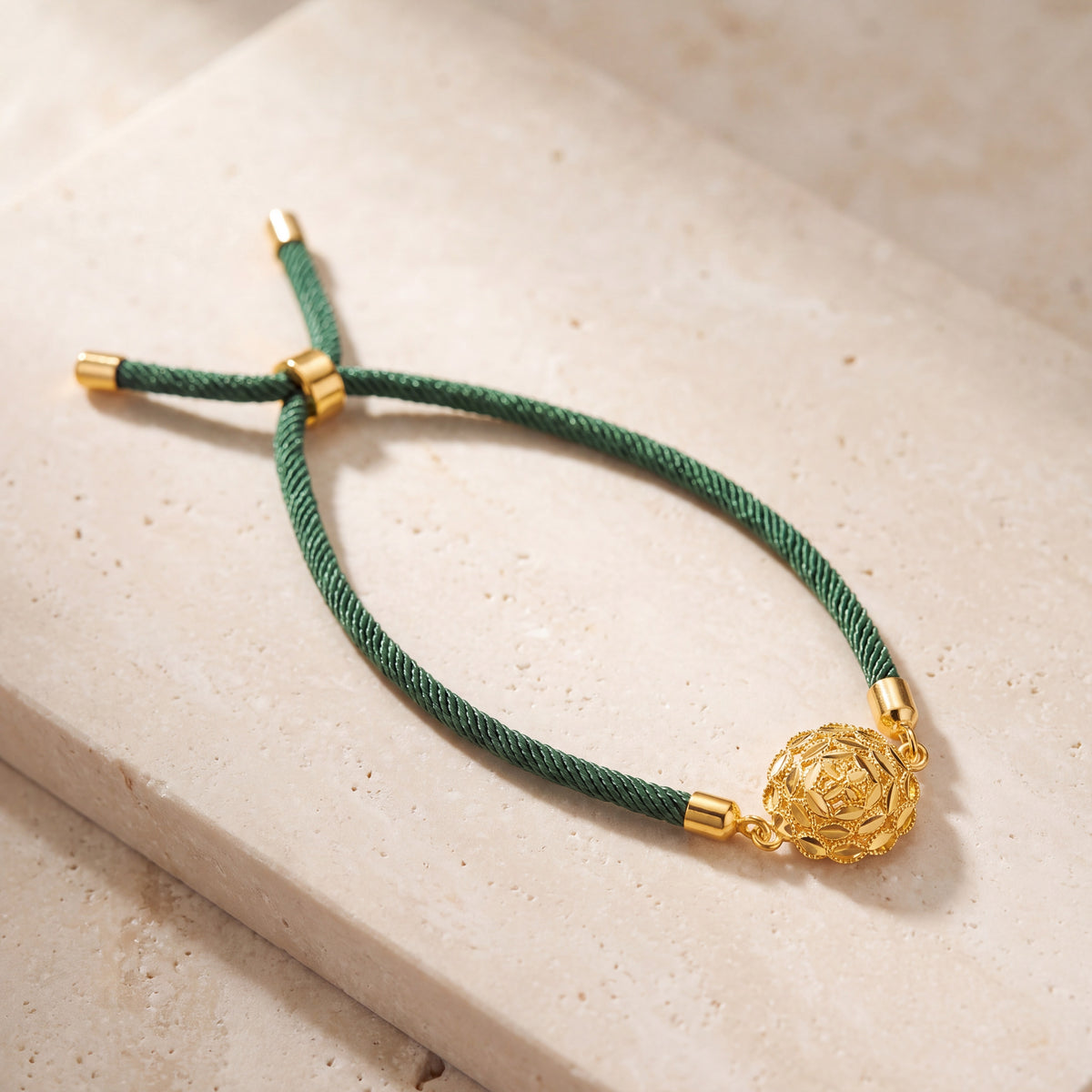 Rose Swirl Thread Bracelet on travertine