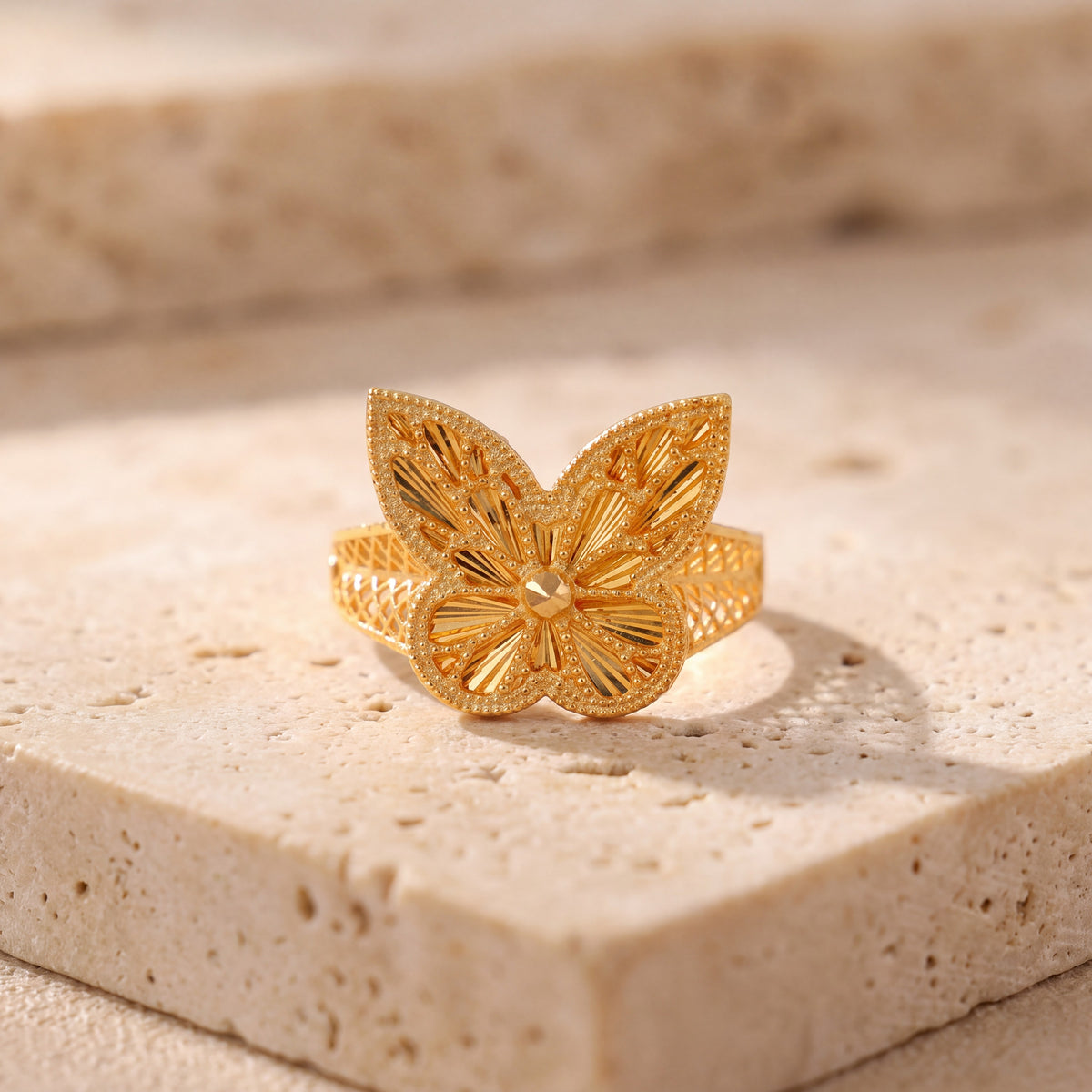 RP Diamond Cut Butterfly Ring (D1) on travertine