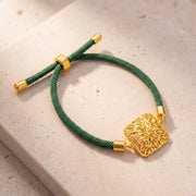 Square Floral Thread Bracelet on travertine