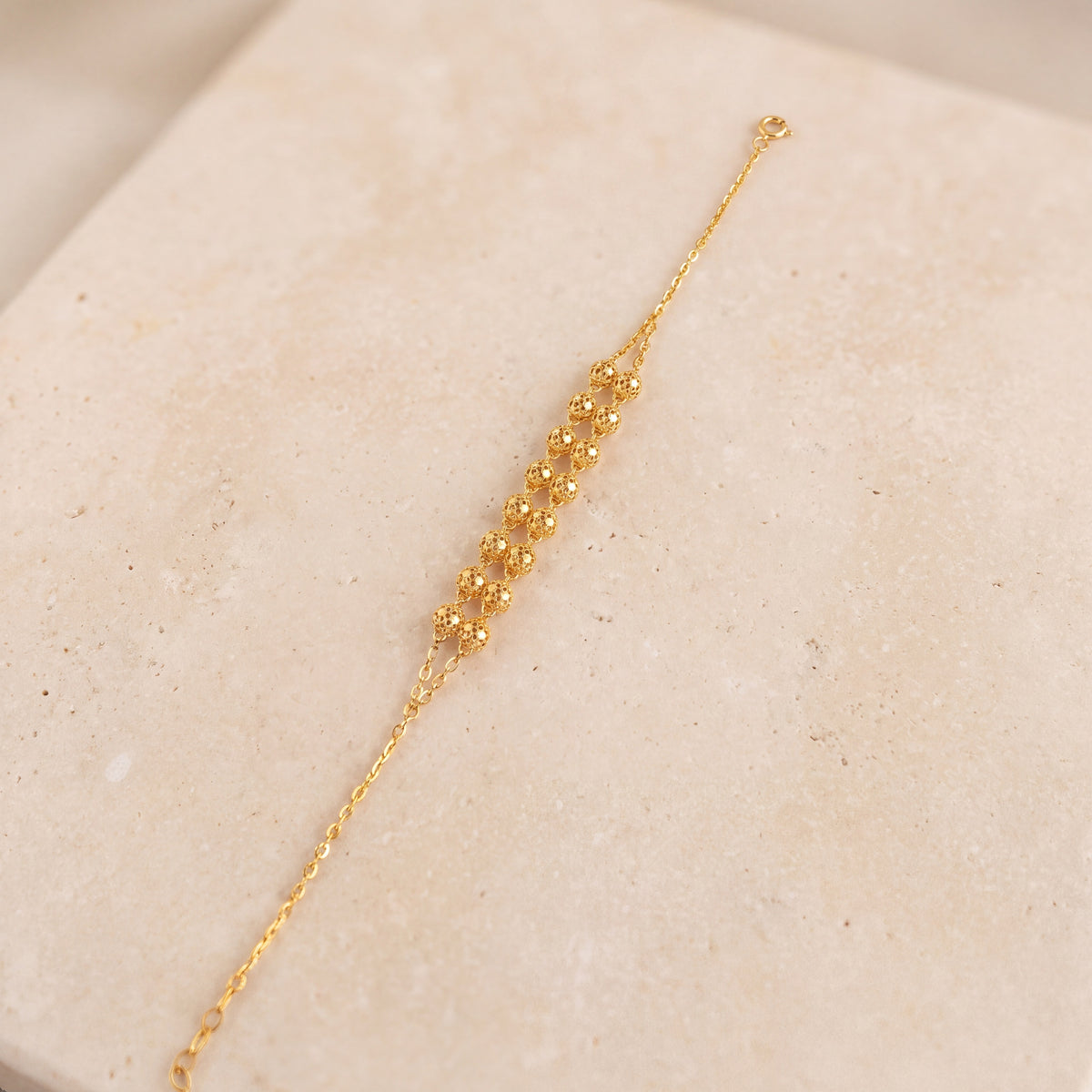 Twin Orb Bracelet (D5) on travertine