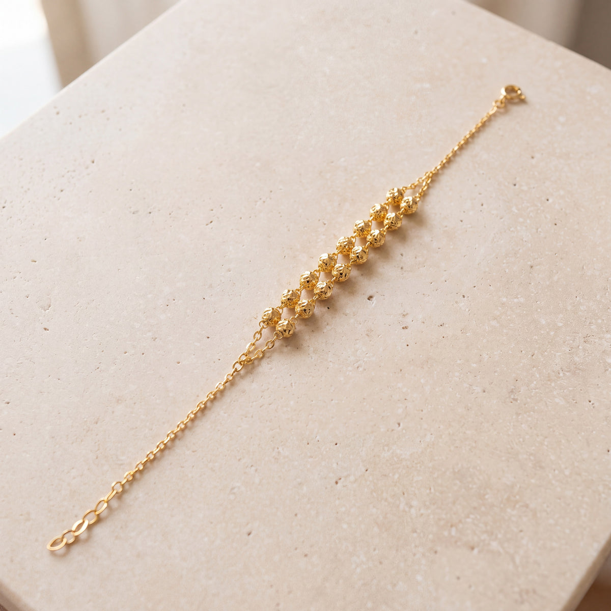 Twin Orb Bracelet (D6) on travertine