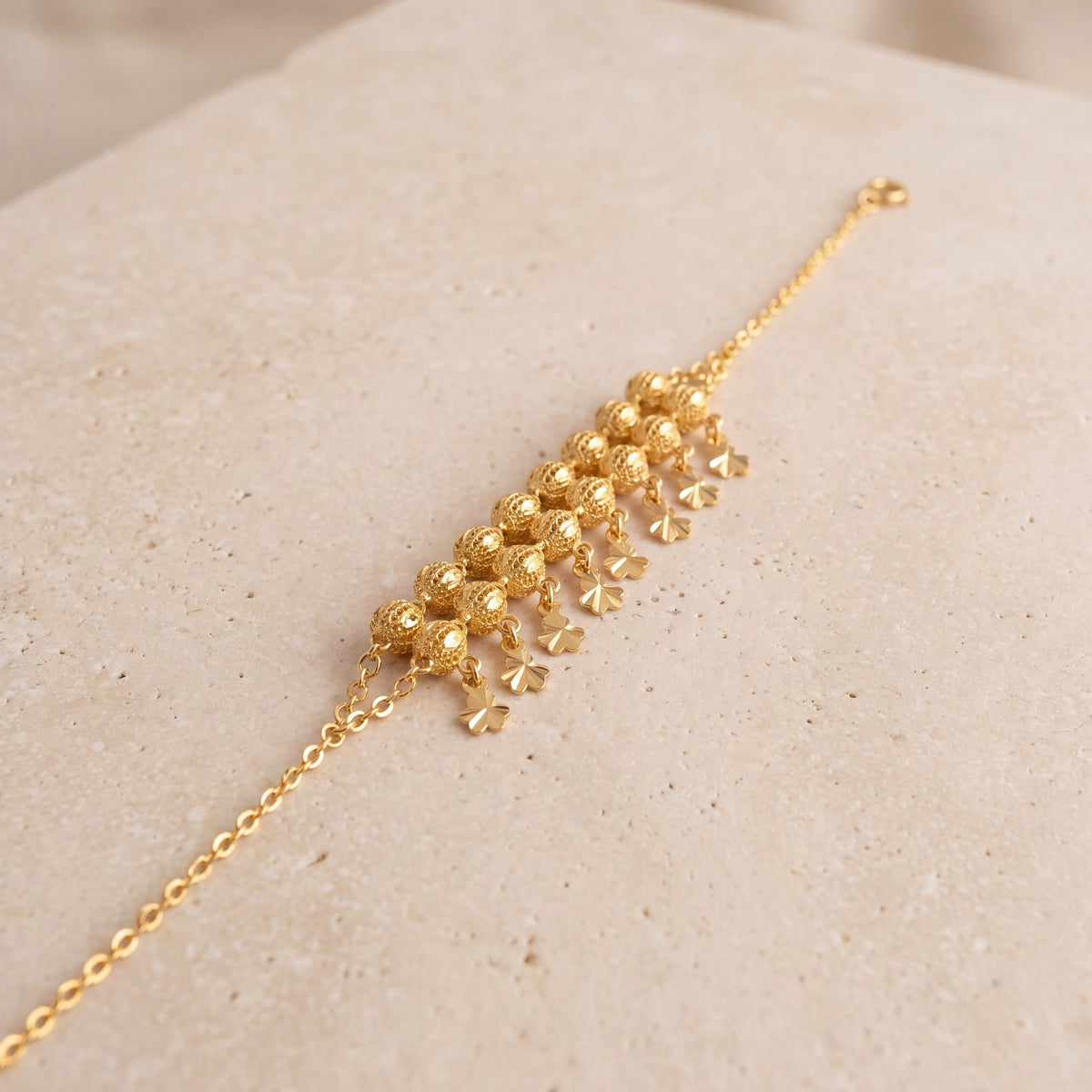Twin Orb Fringe Bracelet (D3) on travertine