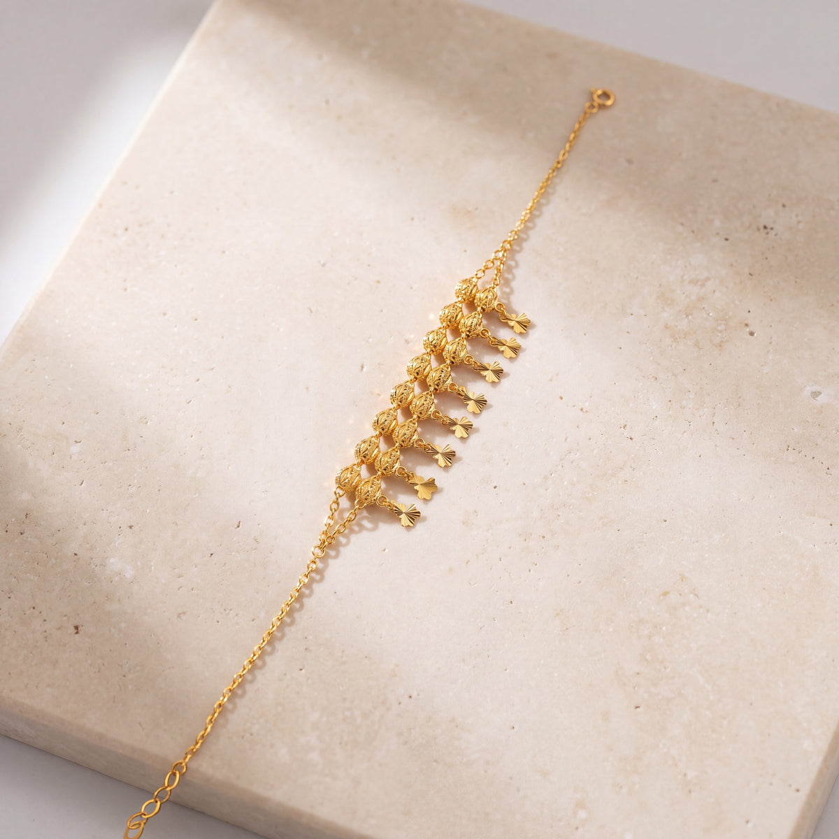 Twin Orb Fringe Bracelet (D4) on travertine