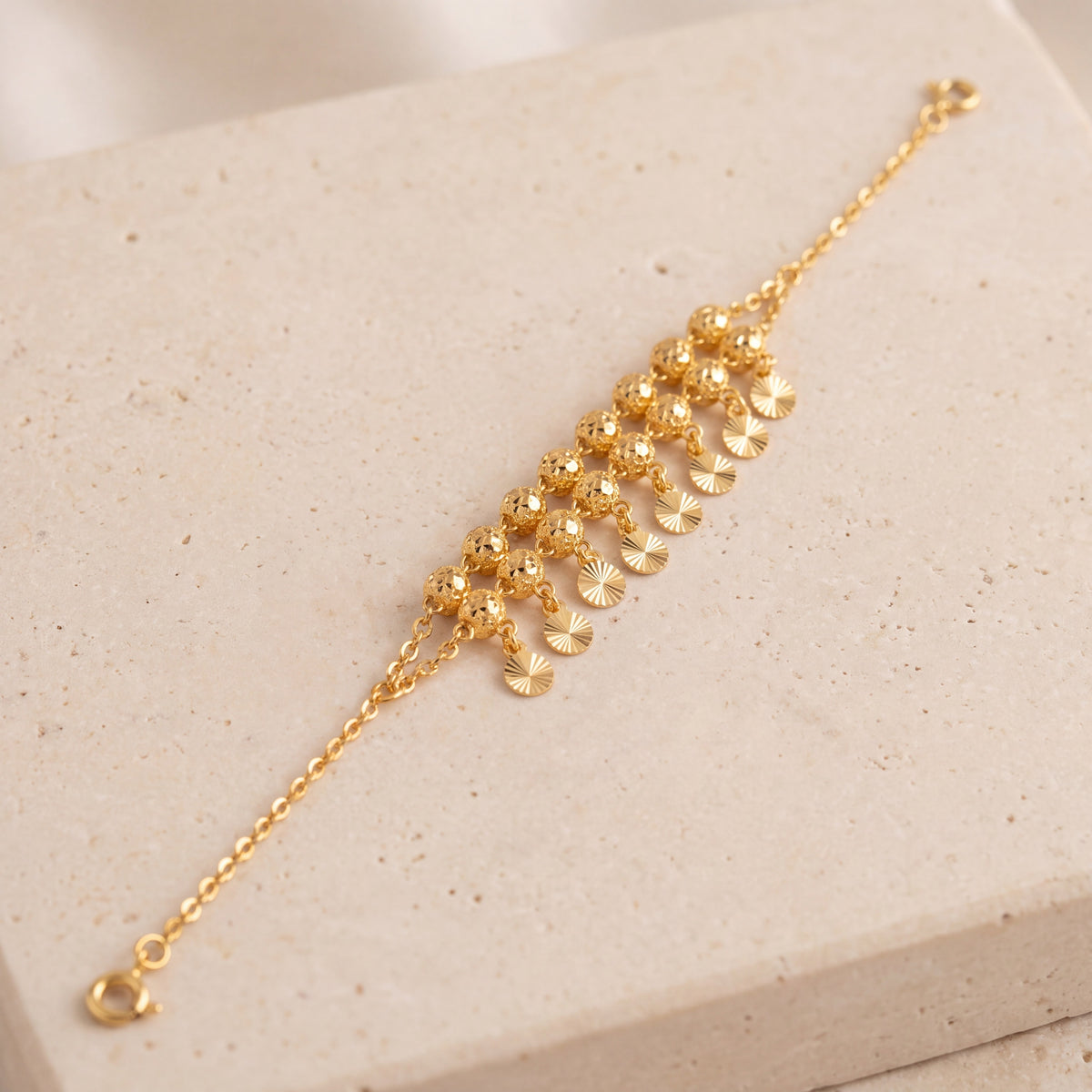 Twin Orb Fringe Bracelet (D5) on travertine