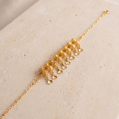 Twin Orb Fringe Bracelet (D7) on travertine